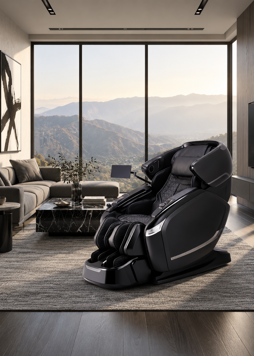 Dark gray and black massage chair in a modern living room overlooking misty mountains.